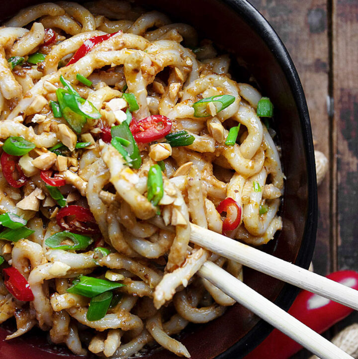 spicy peanut udon in bowl with chopsticks