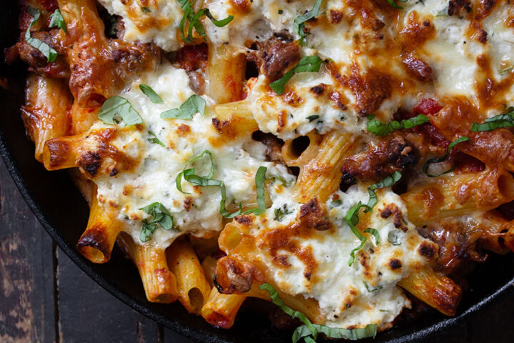baked pasta with sausage and ricotta in cast iron skillet