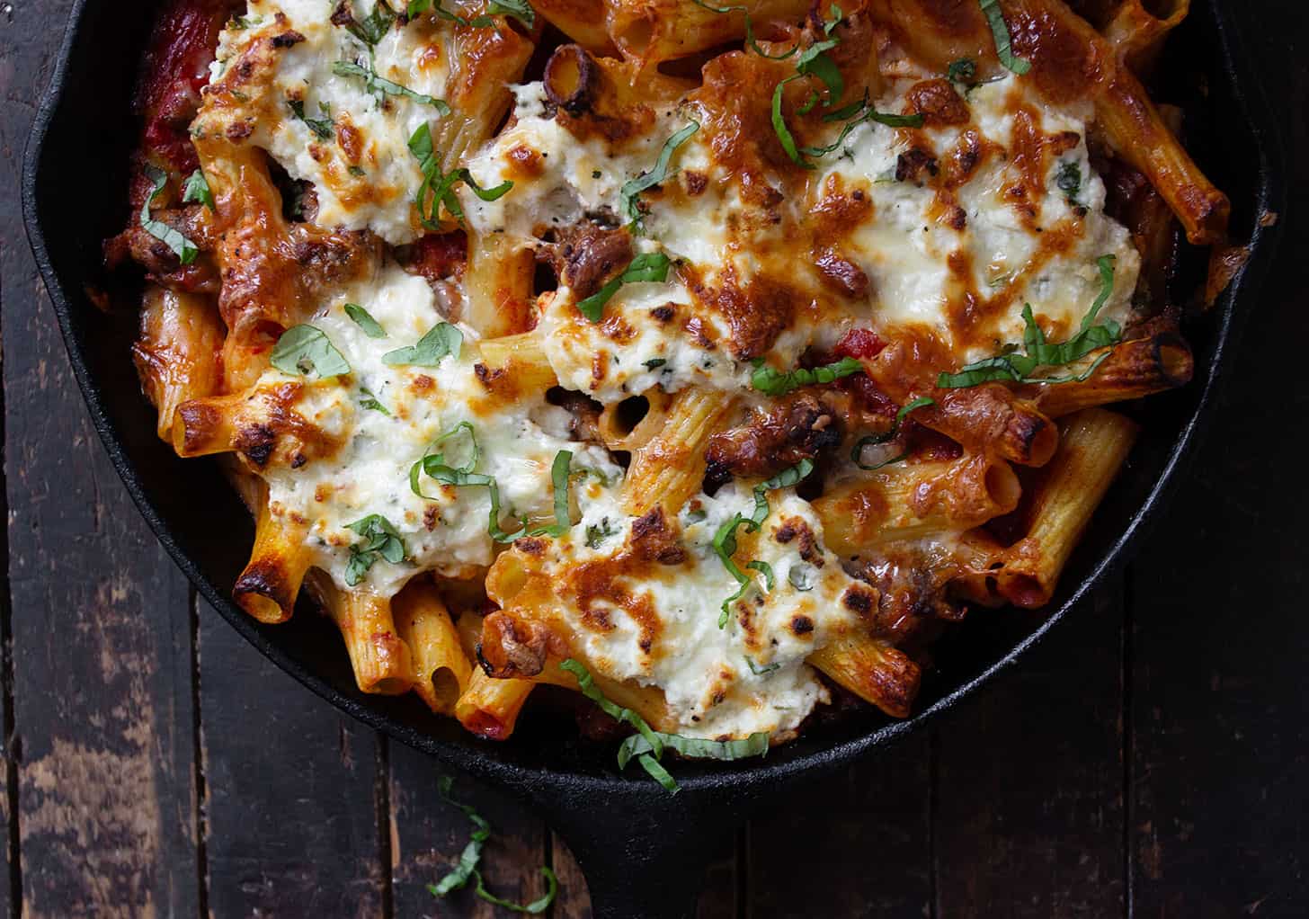 baked pasta with sausage and ricotta in cast iron skillet