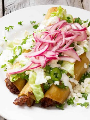 carnitas flautas on plate