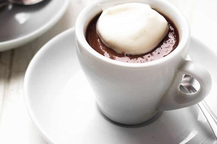 chocolate pudding shots in espresso cups with whipped cream on top