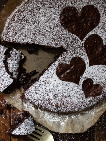 gooey chocolate cake sliced on parchment paper