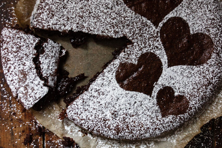 gooey chocolate cake sliced on parchment paper