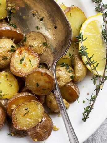 lemon garlic potatoes in white bowl with spoon