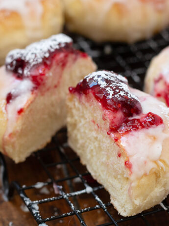 Shrovetide buns cut open on cooling rack.