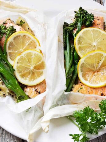 rainbow trout cooked in parchment with lemons, broccolini and pasta