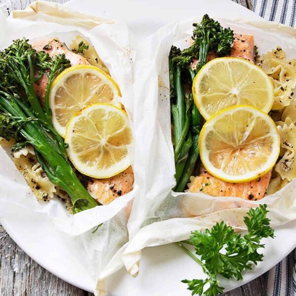 rainbow trout cooked in parchment with lemons, broccolini and pasta