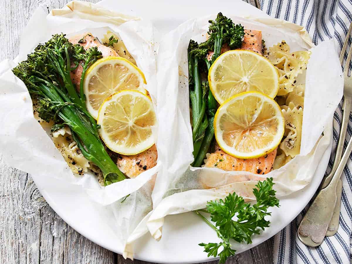 rainbow trout cooked in parchment with lemons, broccolini and pasta