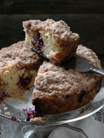 berry crumb cake sliced on cake plate