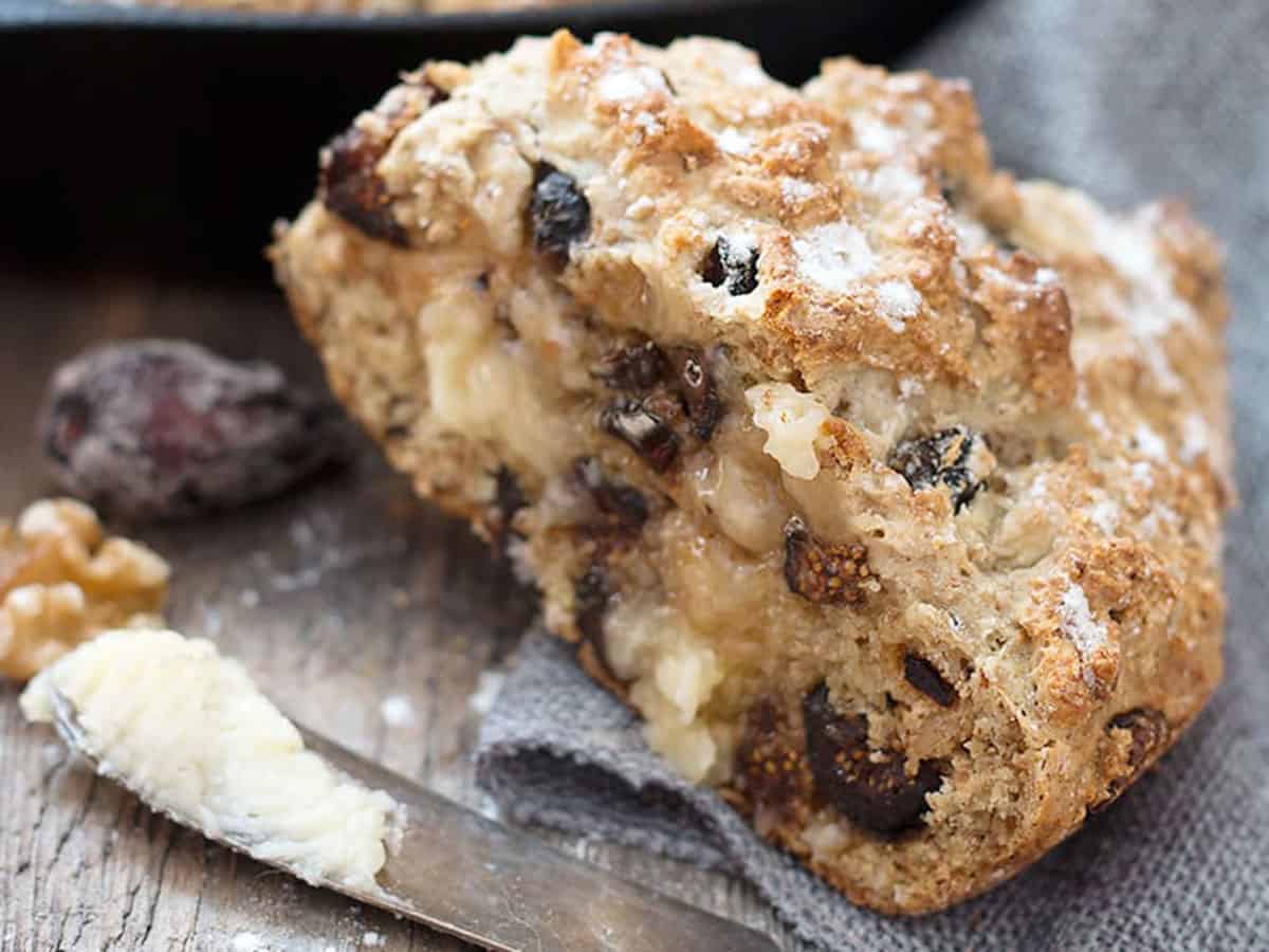 fig and walnut soda bread sliced with knife and butter