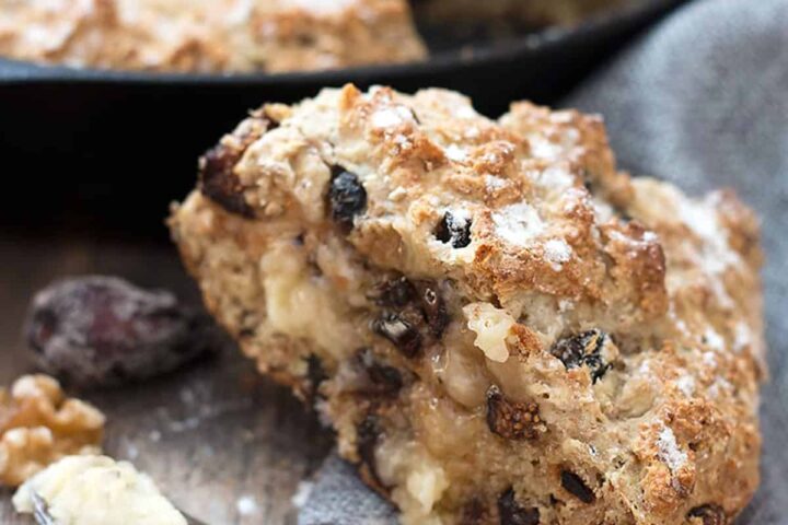 fig and walnut soda bread sliced with knife and butter