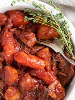 tangy tomato post roast in serving dish with vegetables