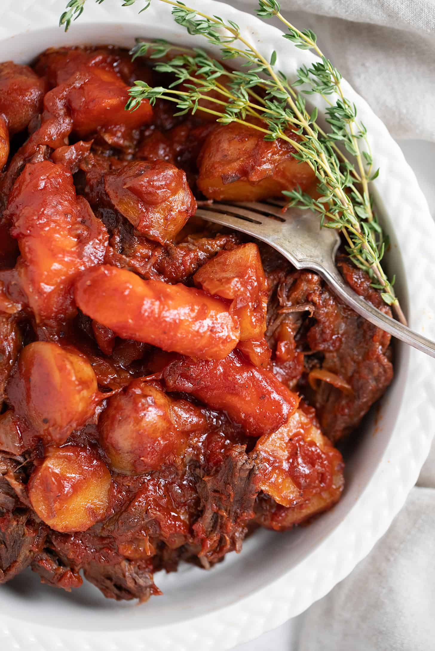 tangy tomato post roast in serving dish with vegetables