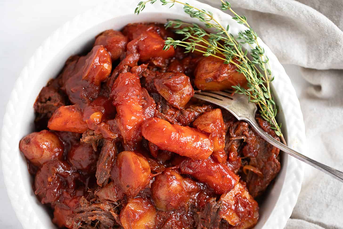 tangy tomato post roast in serving dish with vegetables