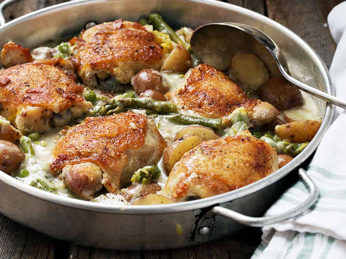 chicken thighs with asparagus and mini potatoes in pan