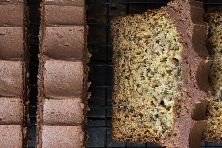 chocolate frosted banana bread sliced on cooling rack