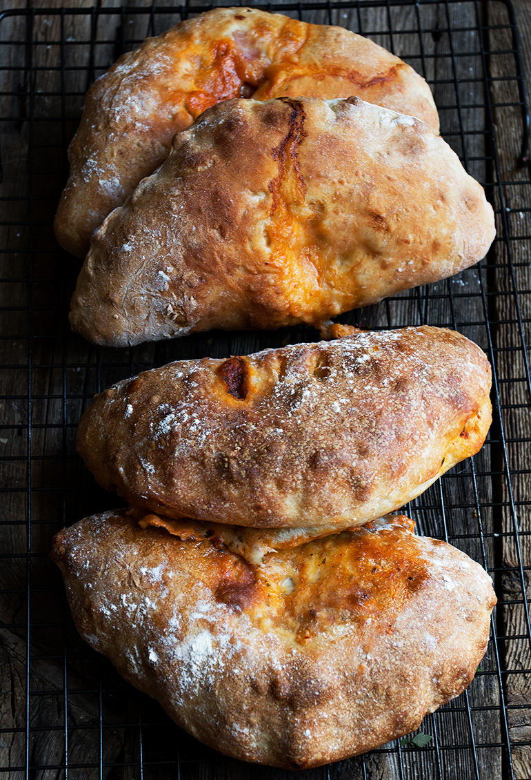 Easy Calzones: Two Ways - start with store-bought pizza dough! With sundried tomato, pesto and bocconcini and Genoa salami, roasted red pepper and provolone versions.