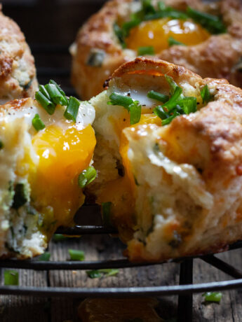 buttermilk biscuits with egg baked on top on cooling rack
