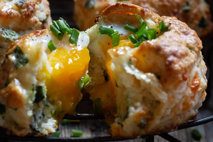 buttermilk biscuits with egg baked on top on cooling rack