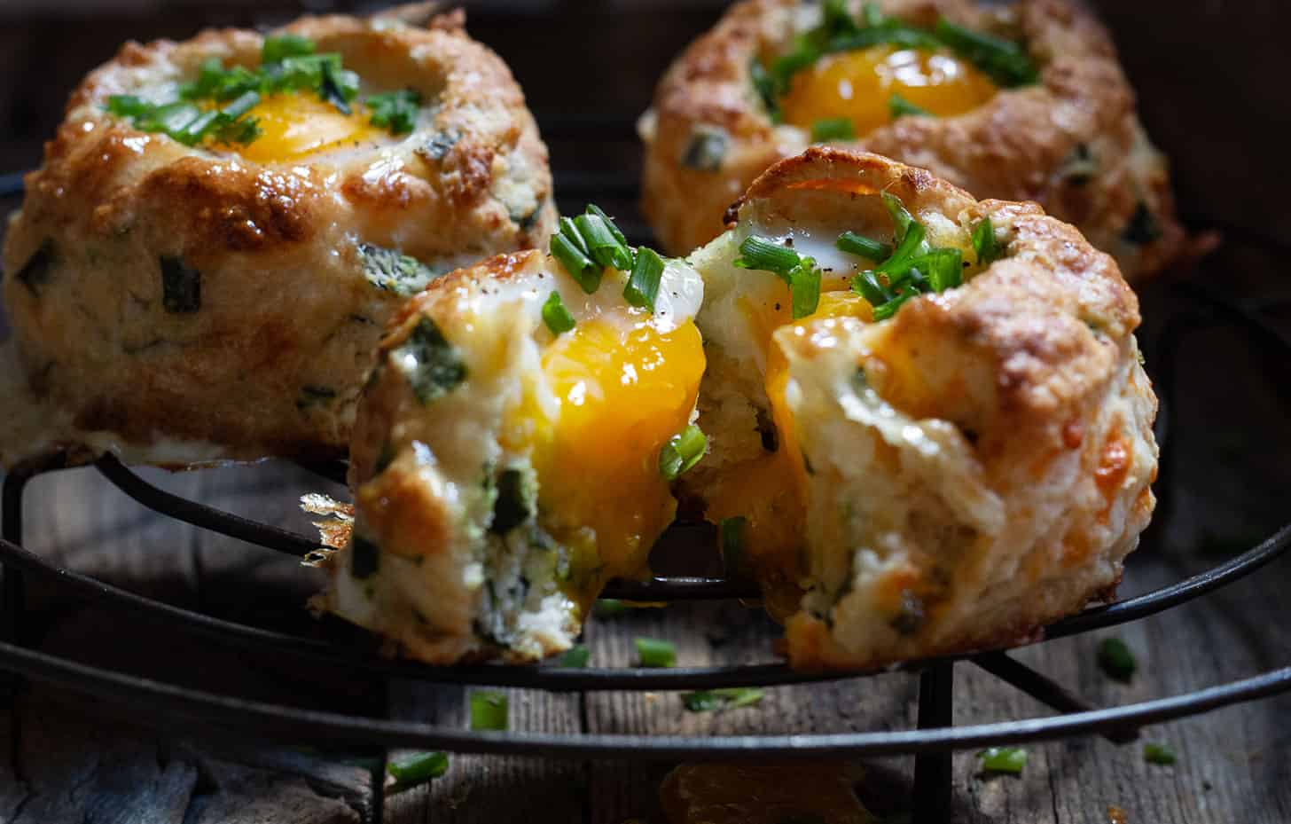 buttermilk biscuits with egg baked on top on cooling rack