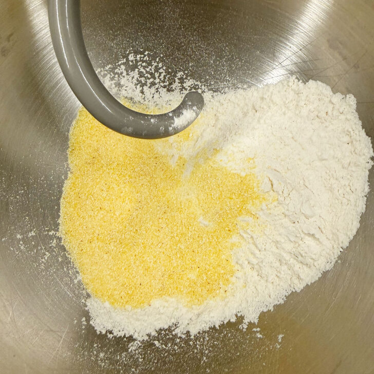 Flour and cornmeal for the dough in a mixing bowl.