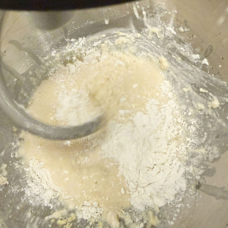 Adding more flour to the deep dish pizza dough.