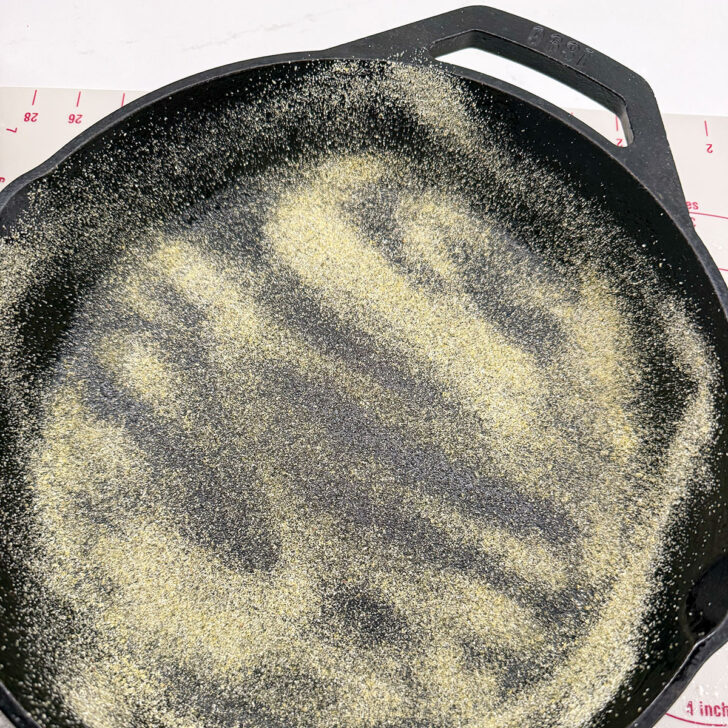 Cast iron skillet dusted brushed with oil and dusted with cornmeal.