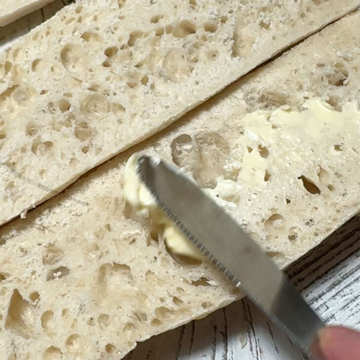 Buttering the ciabatta bread.