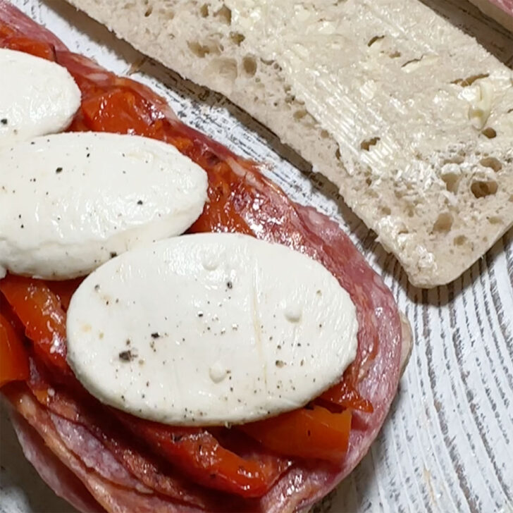 Adding the bocconcini to the sandwiches.