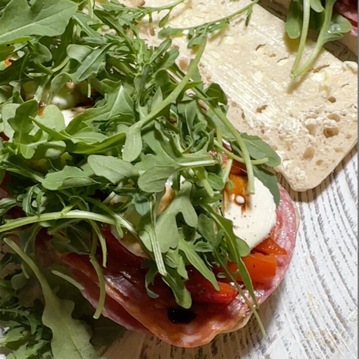 Arugula added to the sandwich.