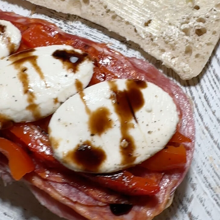 Bocconcini drizzled with balsamic glaze.