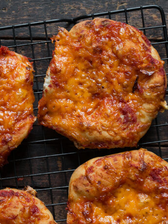 homemade pizza buns on wire cooling rack
