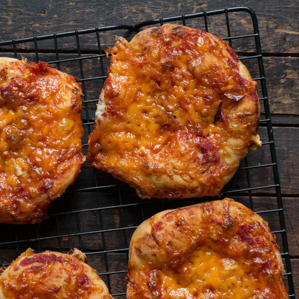 homemade pizza buns on wire cooling rack