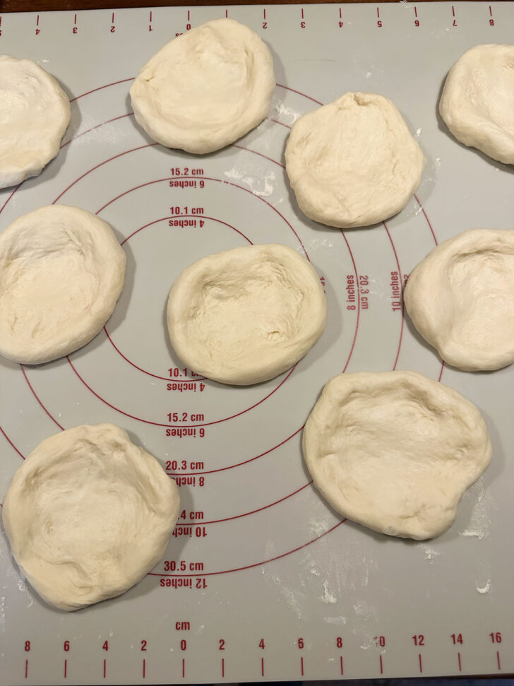 Pizza buns dough balls flattened.