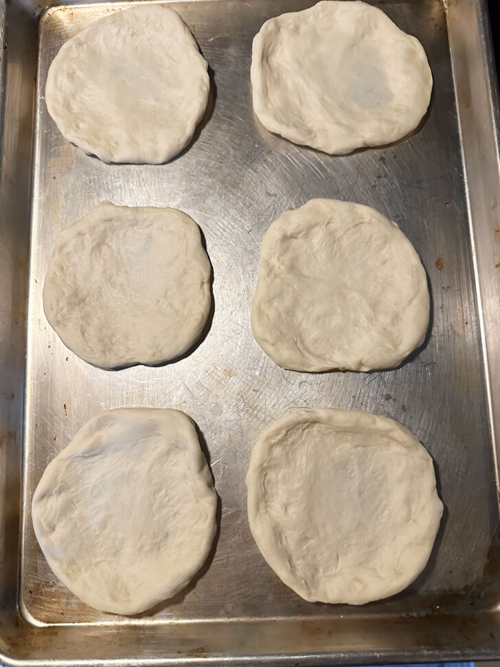 Flattened dough transferred to a baking sheet.