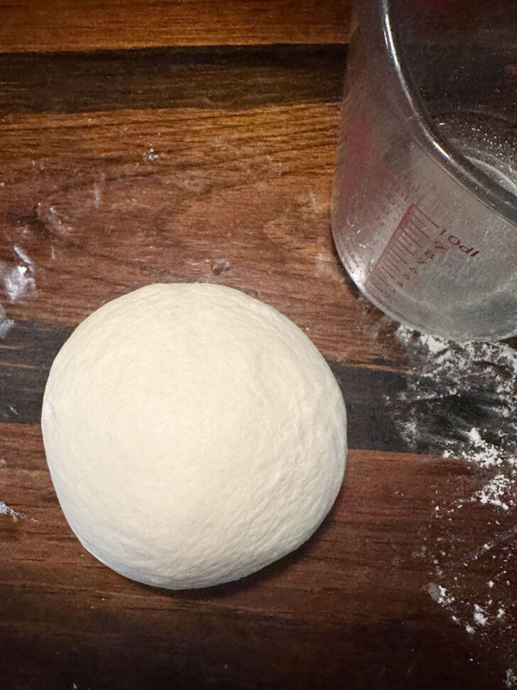 Pizza buns dough formed into a ball before rising.
