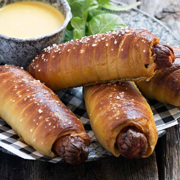pretzel dogs on platter with bowl of honey mustard sauce for dipping