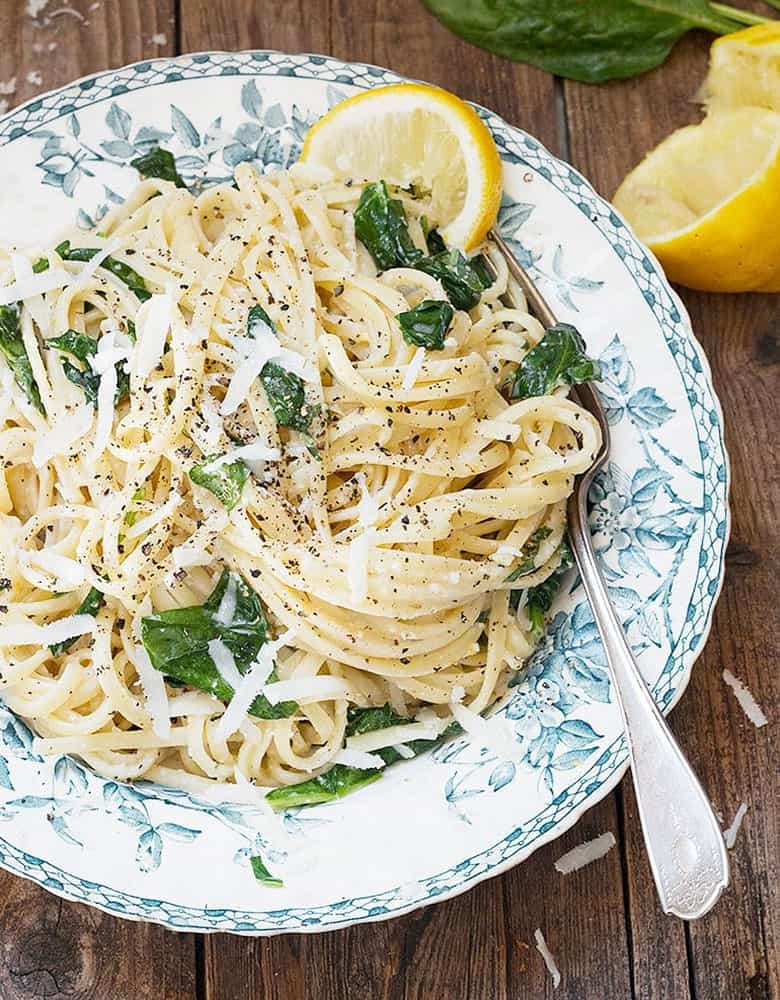 lemon pasta with spinach in bowl with fork