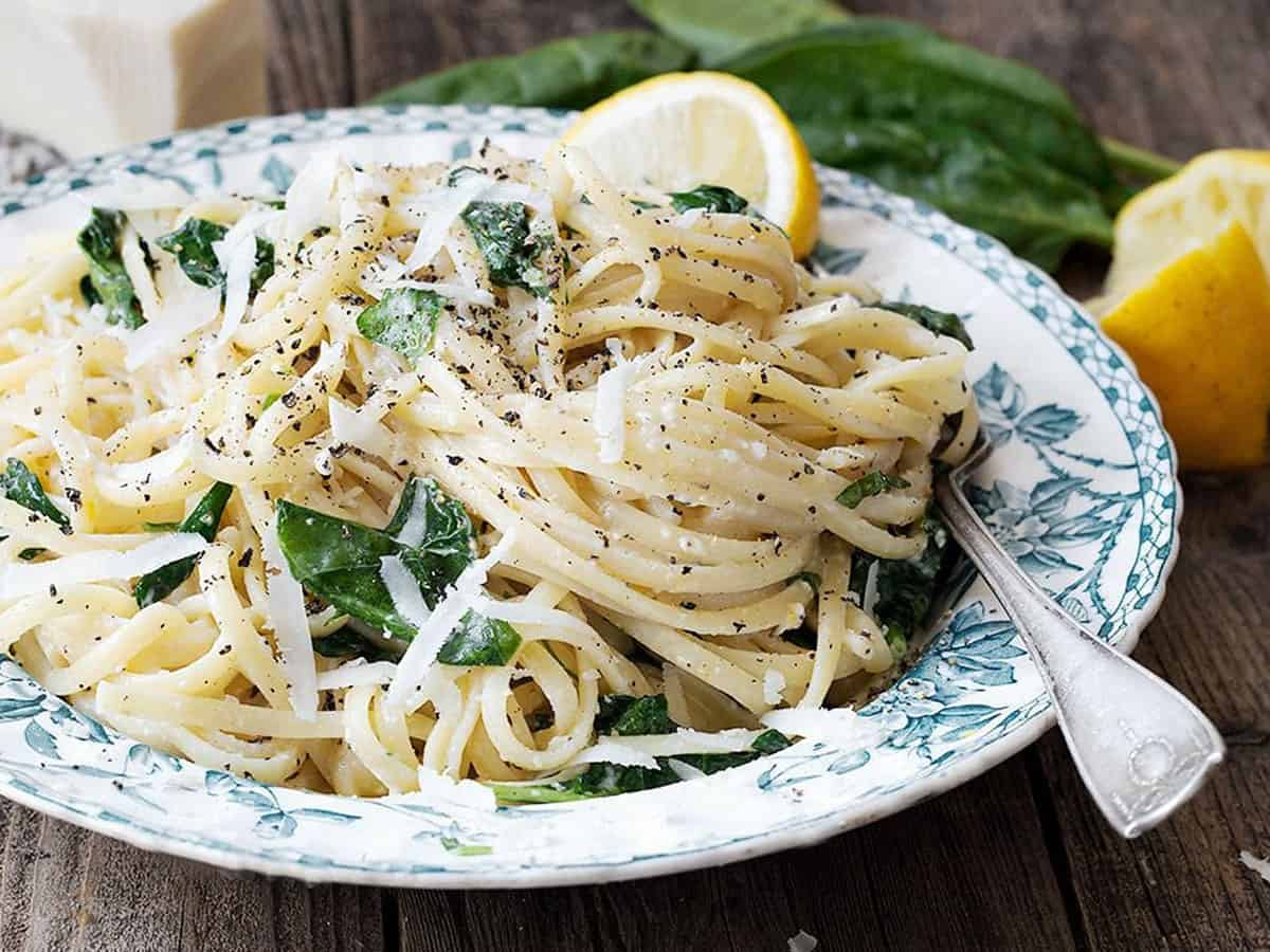 lemon pasta with spinach in bowl with fork