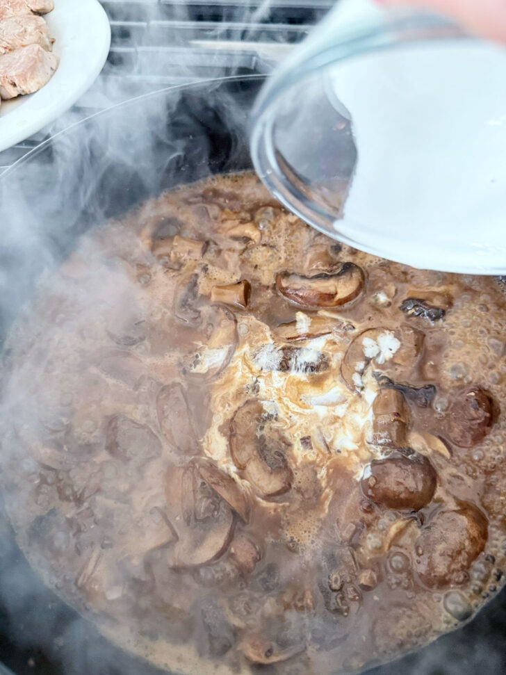 Adding heavy whipping cream to the Marsala mushroom sauce.
