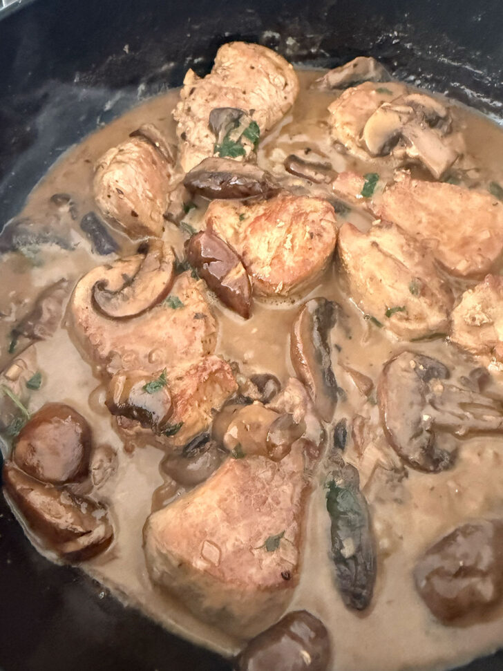 Finished pork Marsala with mushrooms in the skillet.