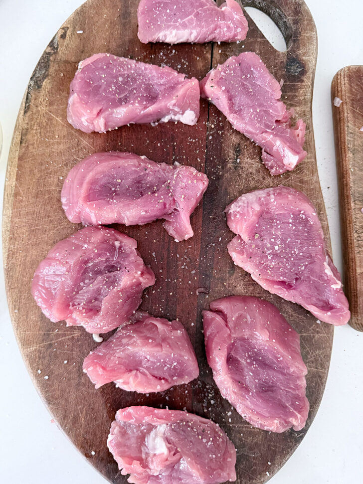 Pork tenderloin cut into medallions and seasoned with salt and pepper.