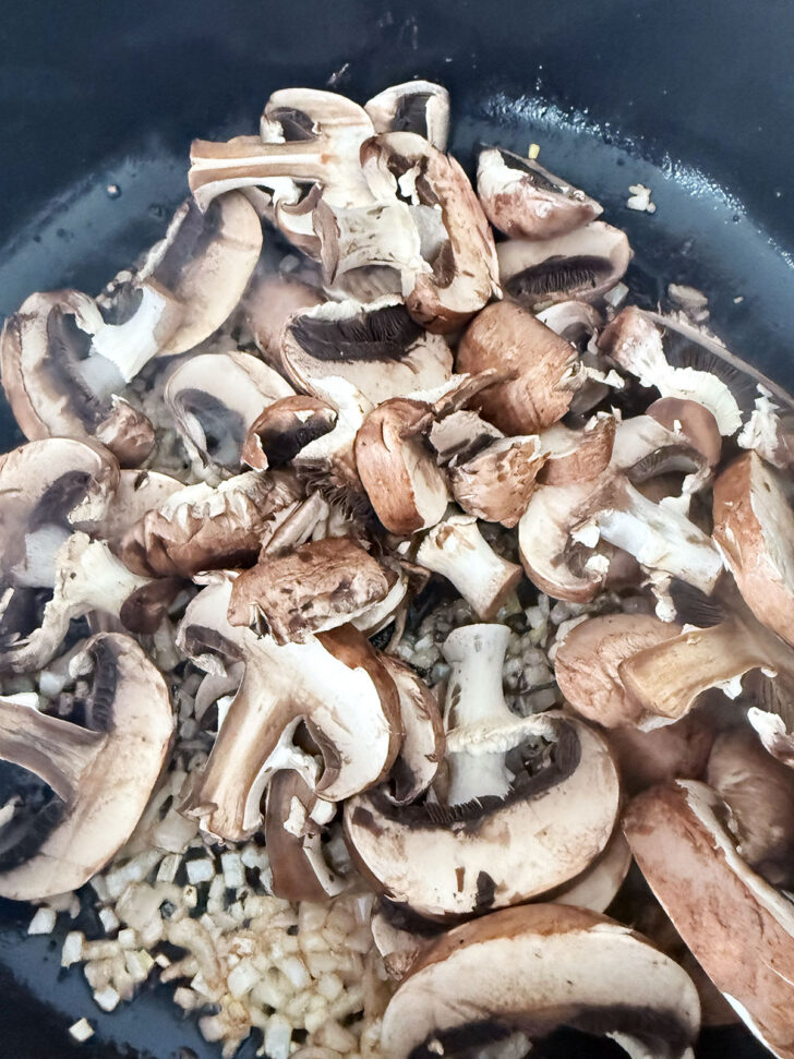 Shallots and mushrooms cooking in the same skillet.