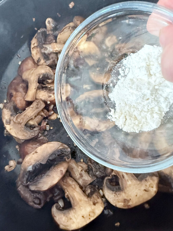 Adding flour to the mushroom and shallot mixture.