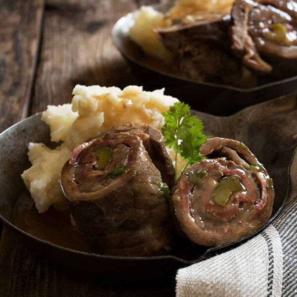 German beef rouladen sliced open in small skillet