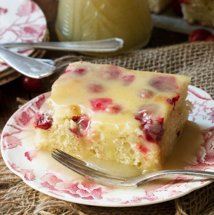 cranberry cake with warm vanilla sauce on plate