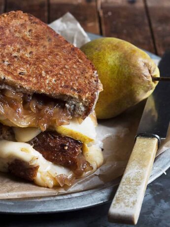 pear grilled cheese with gouda and balsamic onion on platter with pear