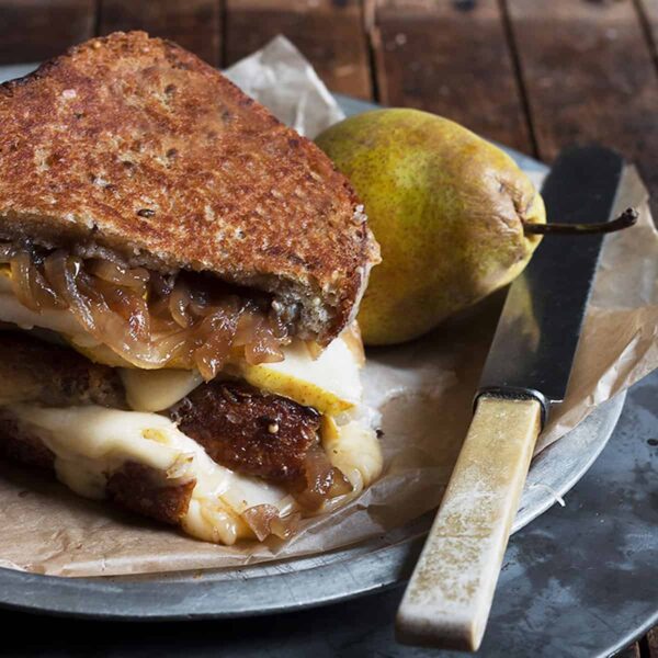 pear grilled cheese with gouda and balsamic onion on platter with pear