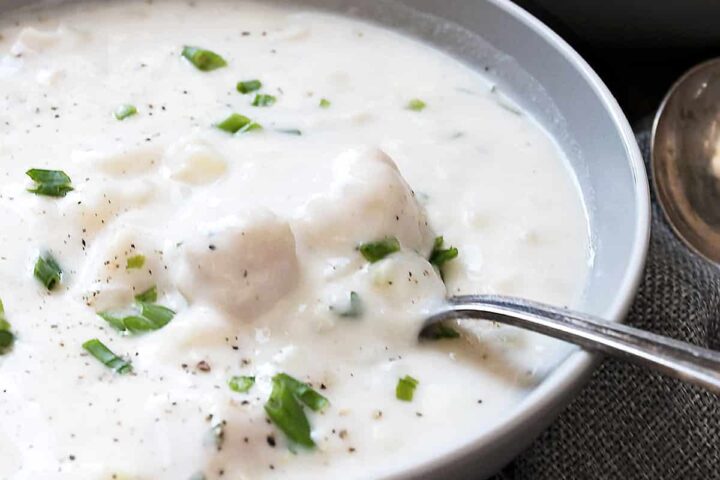 thick and creamy seafood chowder in bowl with spoon