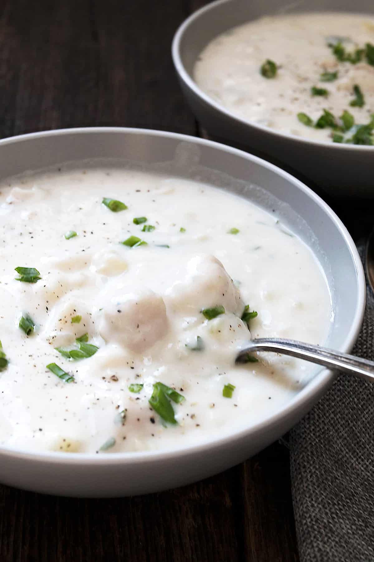 thick and creamy seafood chowder in bowl with spoon